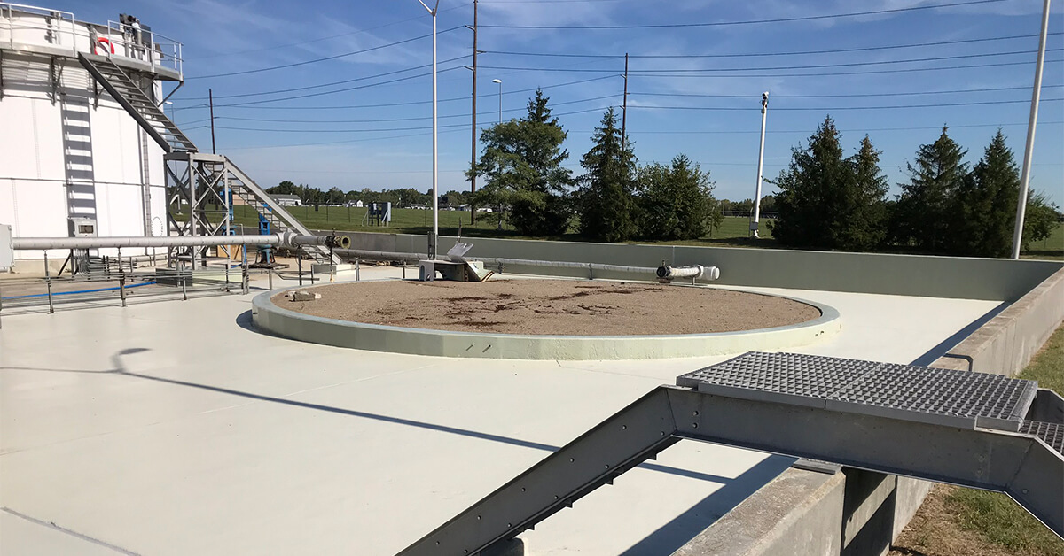An aromatic polyurethane is applied to a concrete clarifier