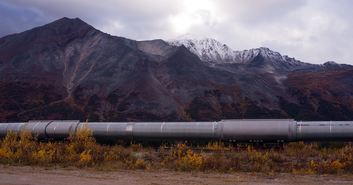 A pipeline, coated to mitigate corrosion, at the foot of a mountain