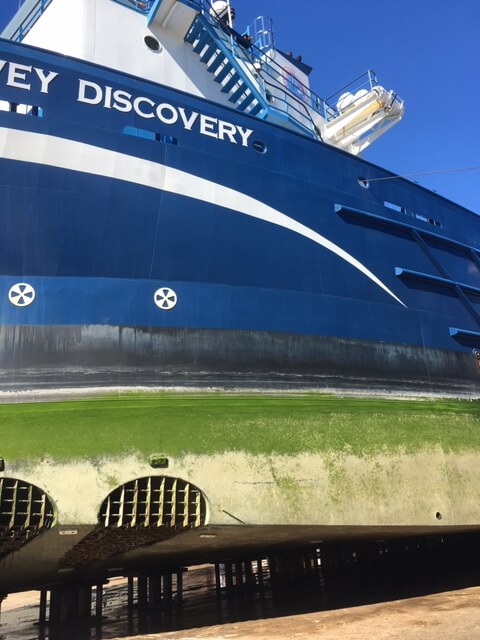 The hull of the ocean supply vessel Harvey Discovery is shown following a wash in 2018, revealing the condition of the coating.