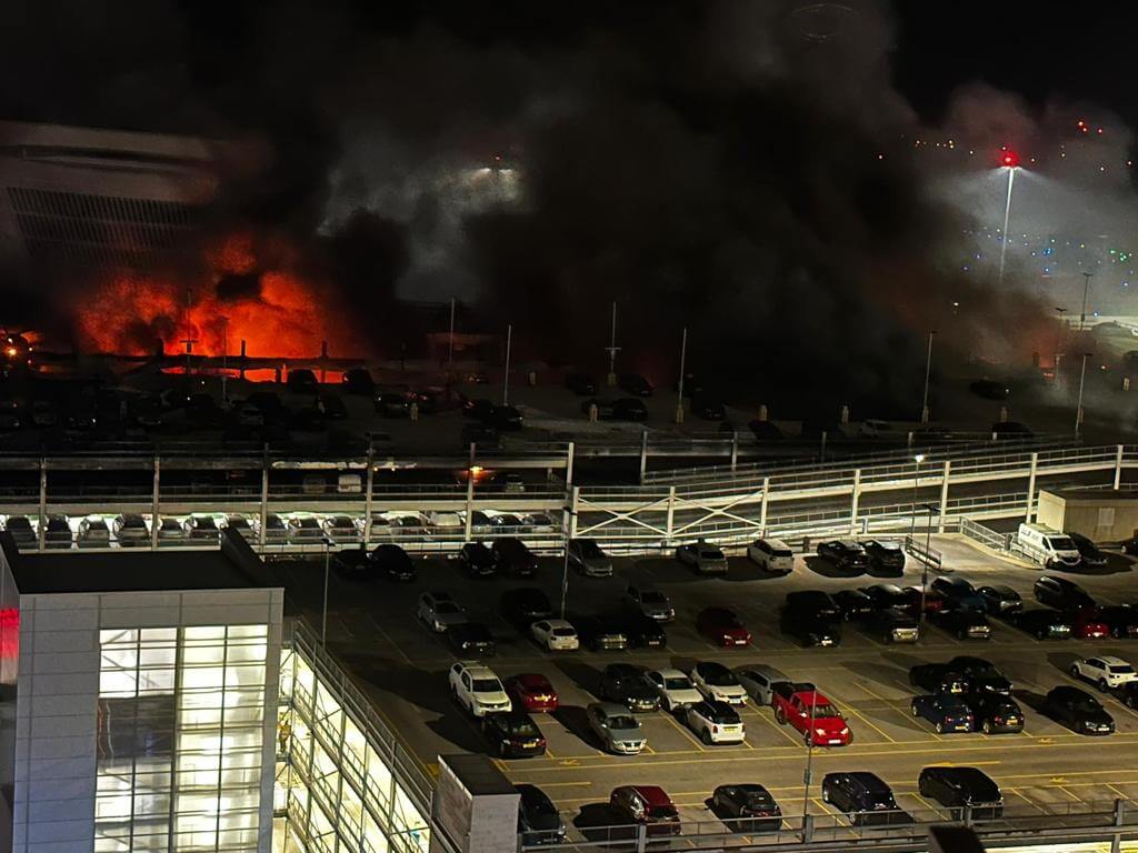 Aerial view of a fire burning inside a parking garage at London Luton Airport, United Kingdom, in 2023.