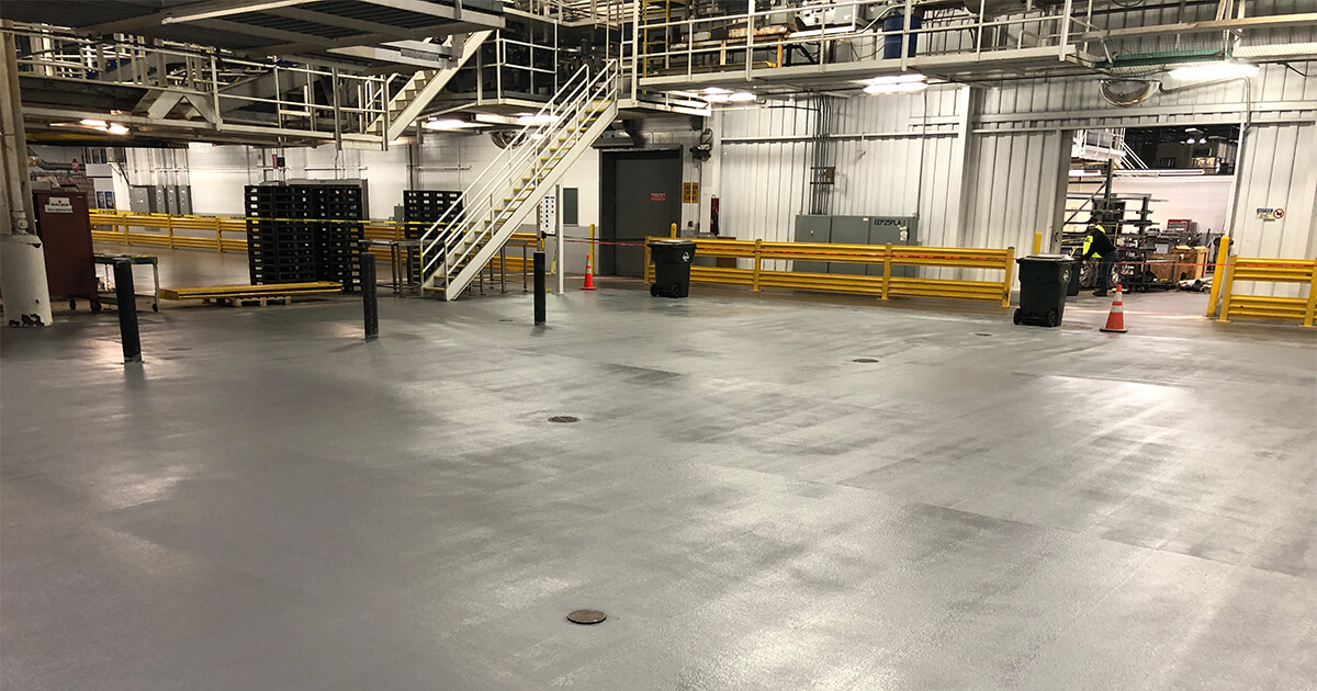 A facility floor protected with a cementitious urethane coating.