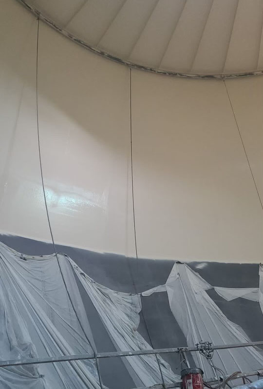 An image of a halfway coated interior surface of a potable water tank.
