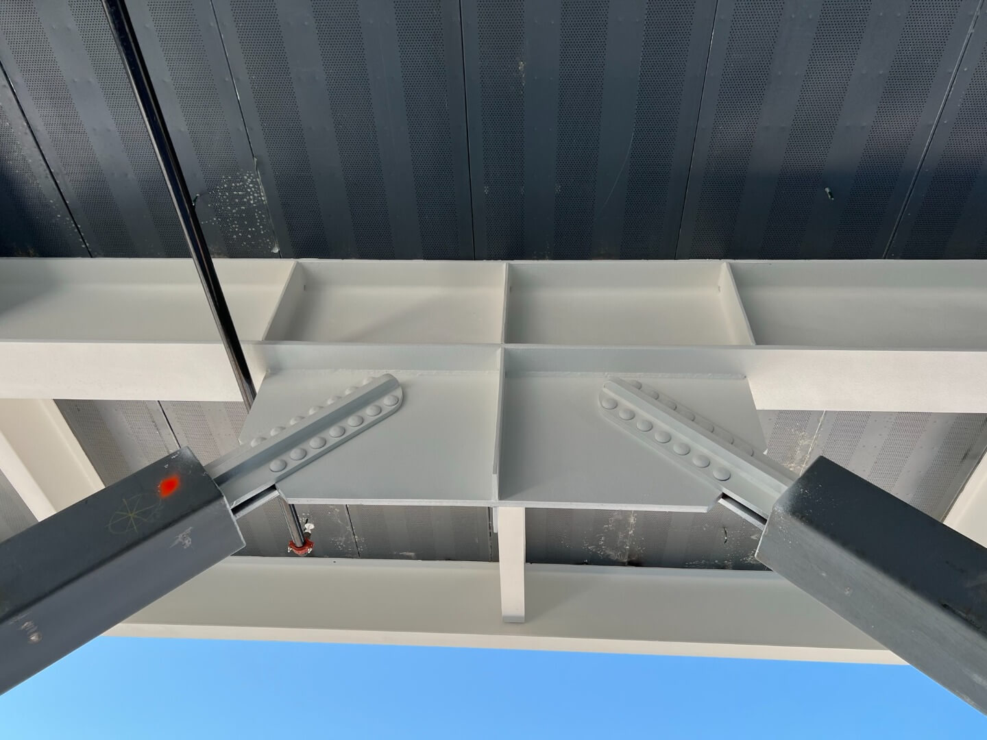 A close-up view of white structural steel members.