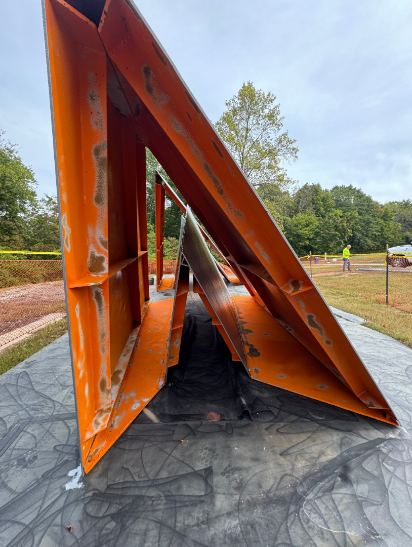 Coating degradation viewed on the underside of a large orange structure.