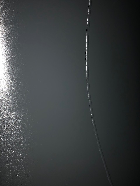 A close-up view of a freshly applied lining on the interior wall of a rail tank car.
